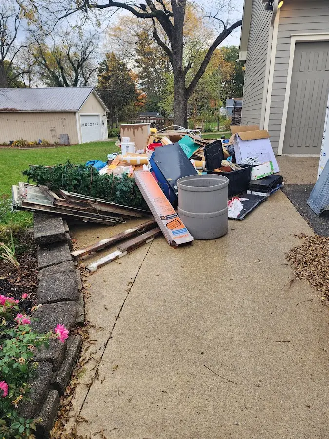 Dumpster being loaded with debris for 12 Yard Dumpster Rental in Vassar